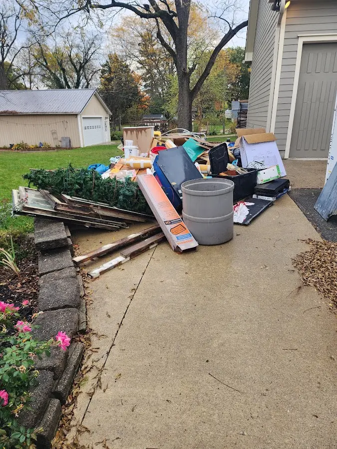 Dumpster being loaded with debris for Estate Cleanout Dumpster Rental in Manchester
